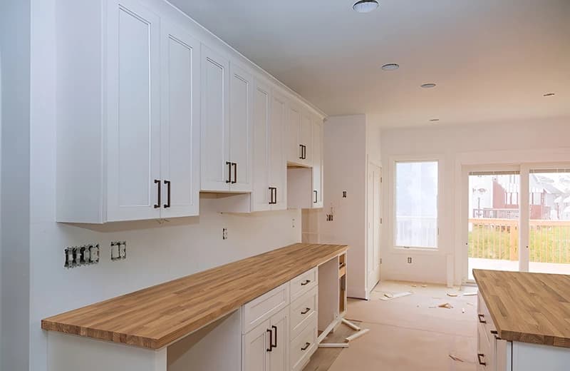 The same kitchen previewed with a solid oak worktop across the run and island