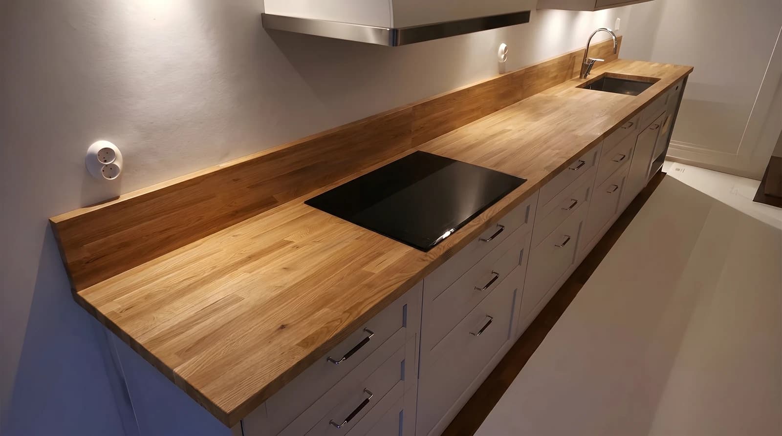 The same kitchen previewed with a solid oak worktop in the room's own light